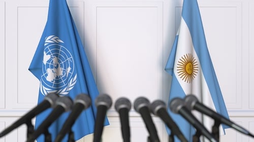 Flags of the United Nations and Argentina at International Press Conference