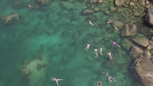Aerial view of People Swimming in Tropical Water