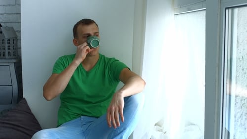 Thougthful Male Hipster Relaxing at Home