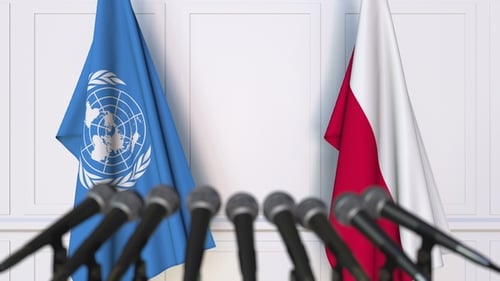 Flags of the United Nations and Poland at International Press Conference
