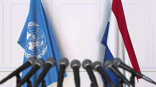 Flags of the United Nations and Netherlands at International Press Conference
