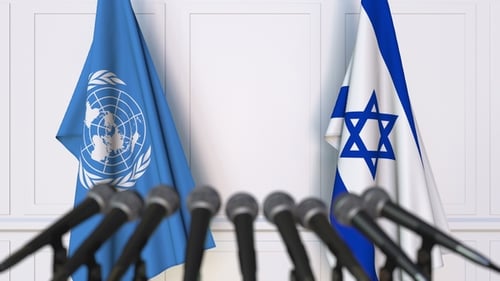 Flags of the United Nations and Israel at International Press Conference