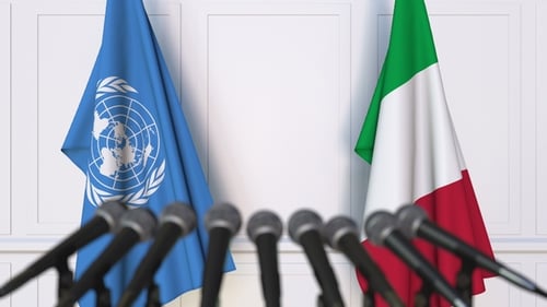 Flags of the United Nations and Italy at International Press Conference