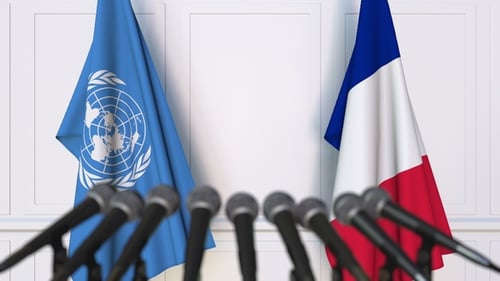 Flags of the United Nations and France at International Press Conference