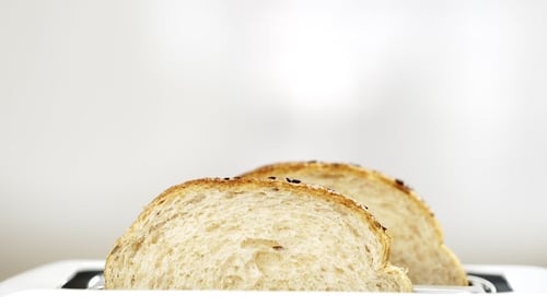Bread Toasting in a White Toaster Close Up