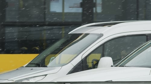 Cars stopped on snowy city street