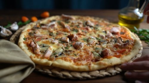 Delicious Pizza with Mushrooms Being Served