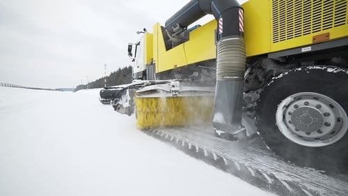 Heavy Wheel Machinery Removes Snow From the Road with Big Massive Rotating Brush in the Snowy