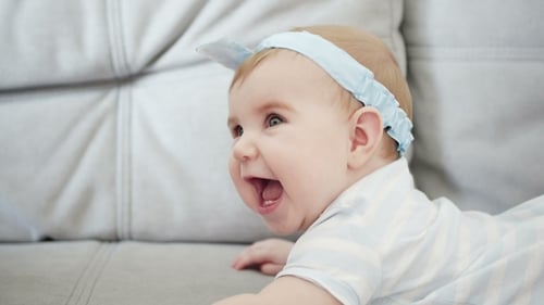 Happy Baby Interacting with an Adult on Couch