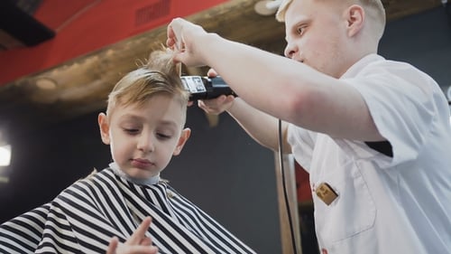 Boy Getting Haircut at the Barber Shop