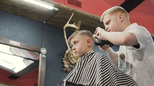 Child Gets Haircut at Trendy Barbershop