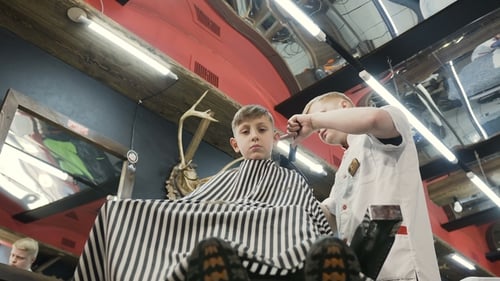 Boy Getting Haircut at Barber Shop