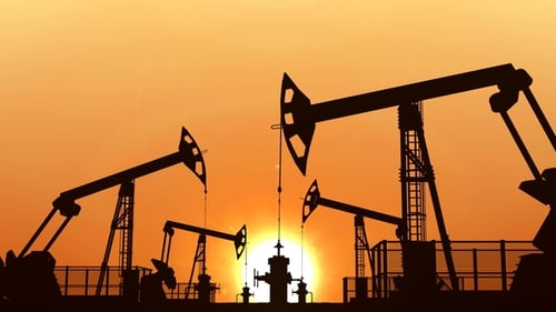 Industrial Oil Pumpjacks Working in Sunset Silhouette