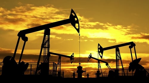 Industrial Oil Pumpjacks Working Silhouetted Against Sunset Sky