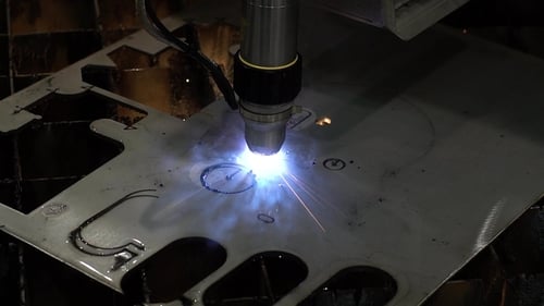 Industrial Machine Cuts Metal Sheet with Sparks