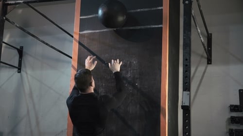 Man Training with Weight Ball