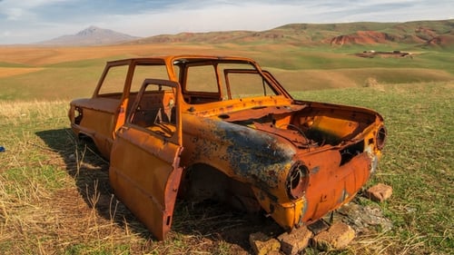 Orange Rusted Antique Car in the Field