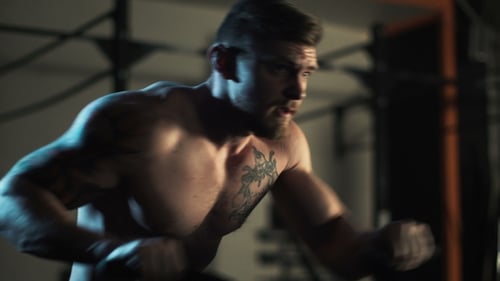 Man Works Out Hard at the Gym