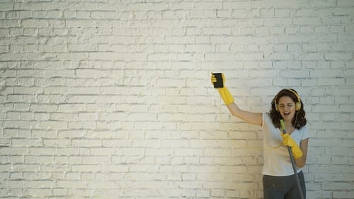 Woman Dancing with Mop While Cleaning Home