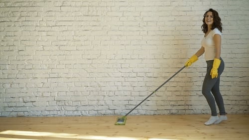 Woman Cleaning Wooden Floor with a Mop