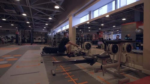 Young Man Training in Fitness Club. Fitness and Sport Lifestyle Concept