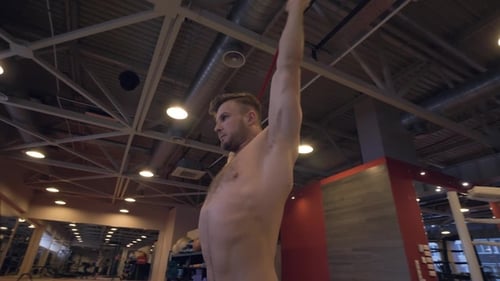 Athlete Man Doing Stretching Exercise with Fitness Equipment in Sport Club