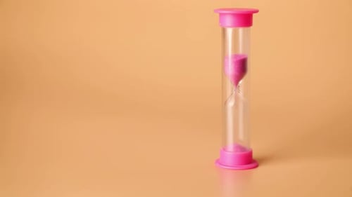 Pink Sand Pouring in Hourglass
