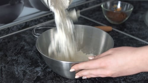 the Girl Pours the Ingredients for the Cupcake Into the Cup.