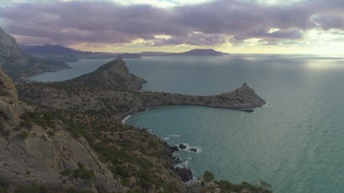 Extremely Fast Drone Flight Over Climber Man Standing on Top of Rock at Sunrise
