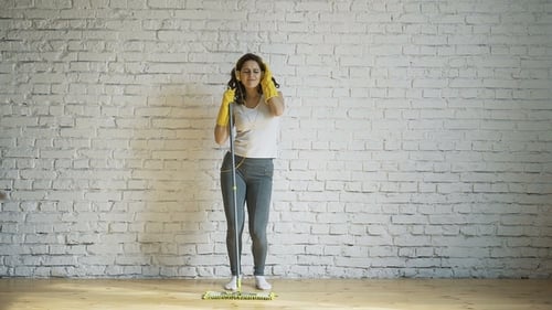 Woman Listening to Music While Cleaning Floor