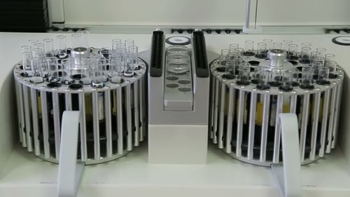 Automated Machine Processes Test Tubes in Laboratory
