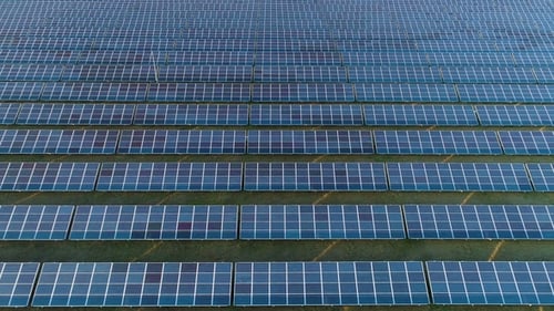 Large Field of Blue Photovoltaic Solar Panels. Aerial View. Flying Sideways To the Right