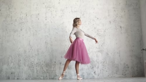 Elegant Ballerina Dances in Studio