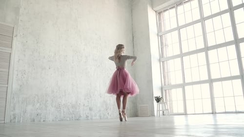 Graceful Ballerina Dancing in Bright Studio