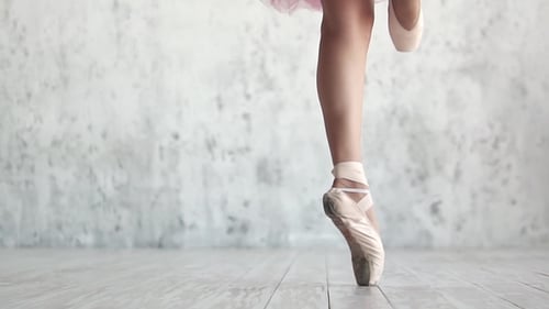 Elegant Ballet Dancer Performing Intricate Footwork in Studio