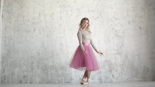 Blonde Ballerina Gracefully Dancing in Ballet Studio