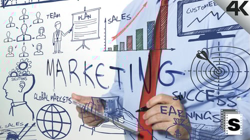 Man Drawings Marketing Plan on Glass Board