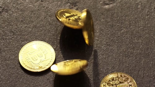 Gold Bitcoin Coins Rotating and Falling