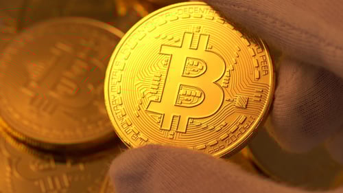Close Up of Gold Bitcoin Being Held
