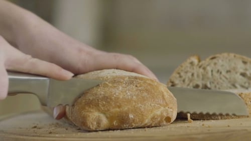 Slicing a Fresh Crusty Loaf of Bread