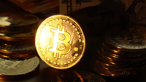 Bitcoin Coin is glowed with golden Light and gradually fades.