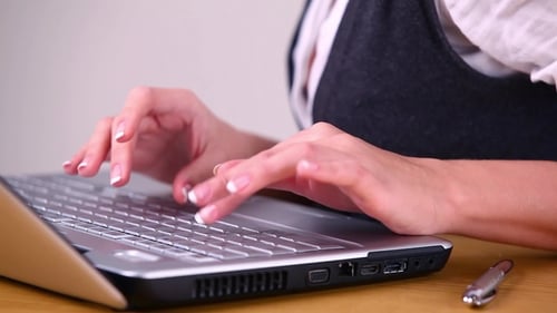 Woman Working at Home on Laptop Computer