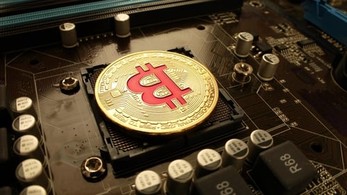 Gold Bit Coin BTC Coins on the Motherboard. Bitcoin Is a Worldwide Cryptocurrency
