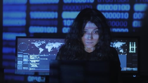 Woman Hacker Programmer with Curly Hair Is Working on Computer in Cyber Security Center