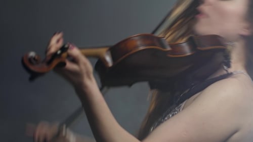 Glamorous Woman Plays Violin in Studio