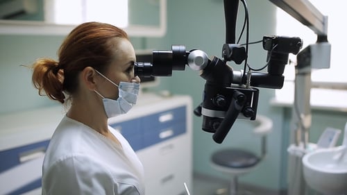 Dentist Examining Patient with Dental Microscope