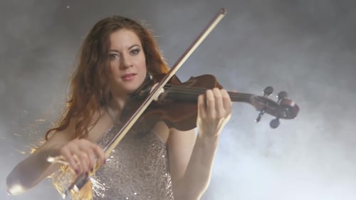 Woman Playing Violin in Smoky Room