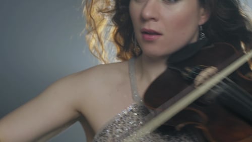 Woman Plays Violin With Expressive Passion