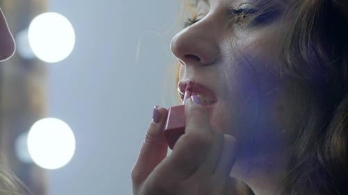 Professional Visagiste Makes Bright Makeup for Woman in Beauty Parlor