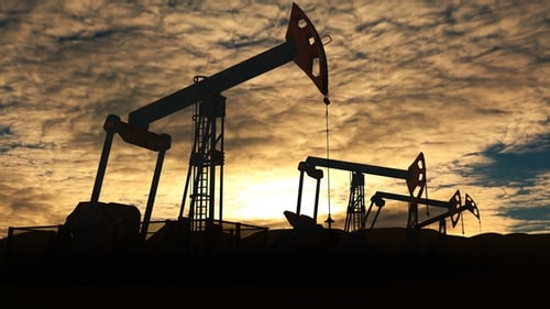 Industrial Oil Pumpjacks Silhouetted Against a Sunset Sky